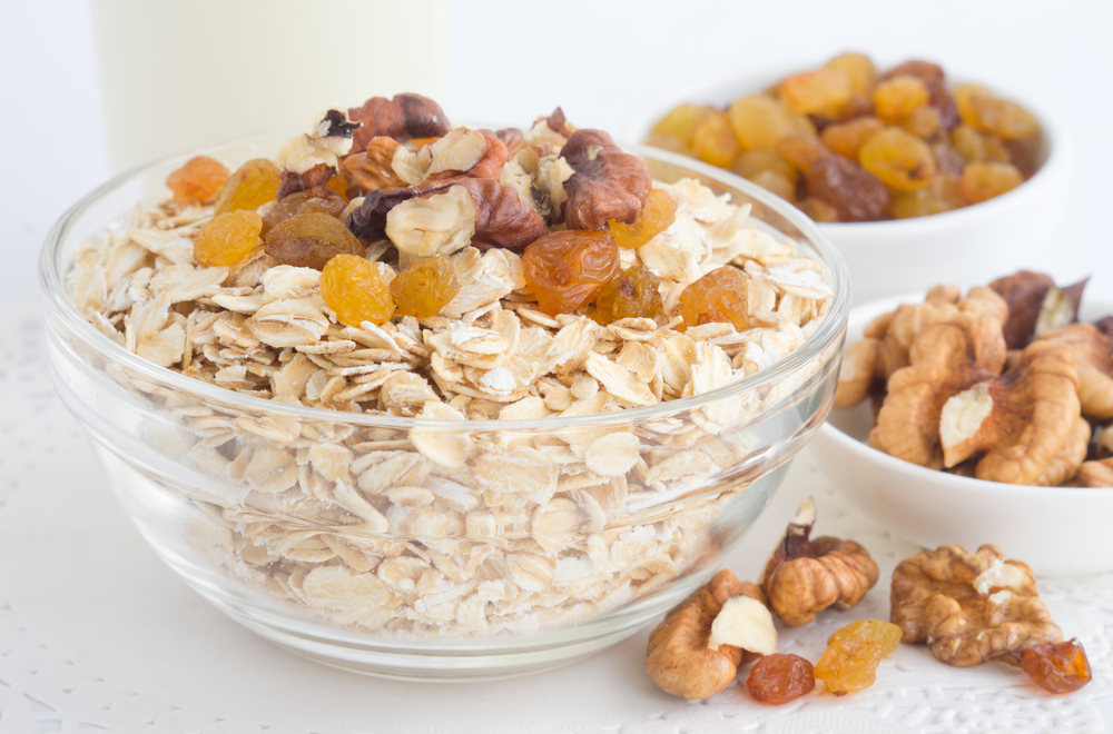 Oats, nuts and dried fruits in a cup.